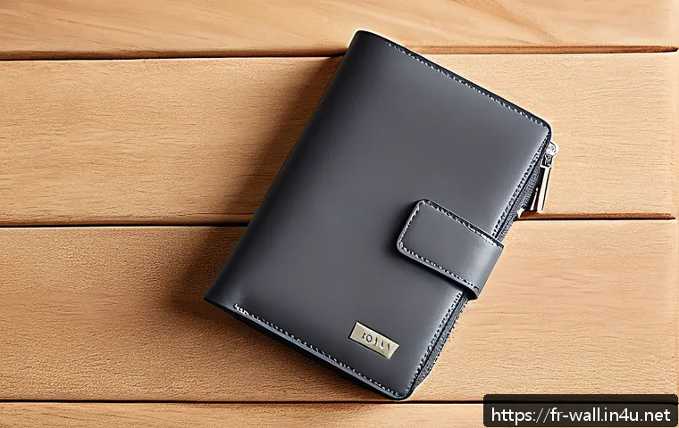 DKNY의 트래블 지갑과 명함 홀더 리뷰 - A sleek, modern DKNY travel wallet made of premium full-grain leather in anthracite gray, displayed ...